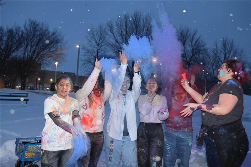 Students laugh under a cloud of colour during the Holi celebrations at Portage College in Lac La Biche.