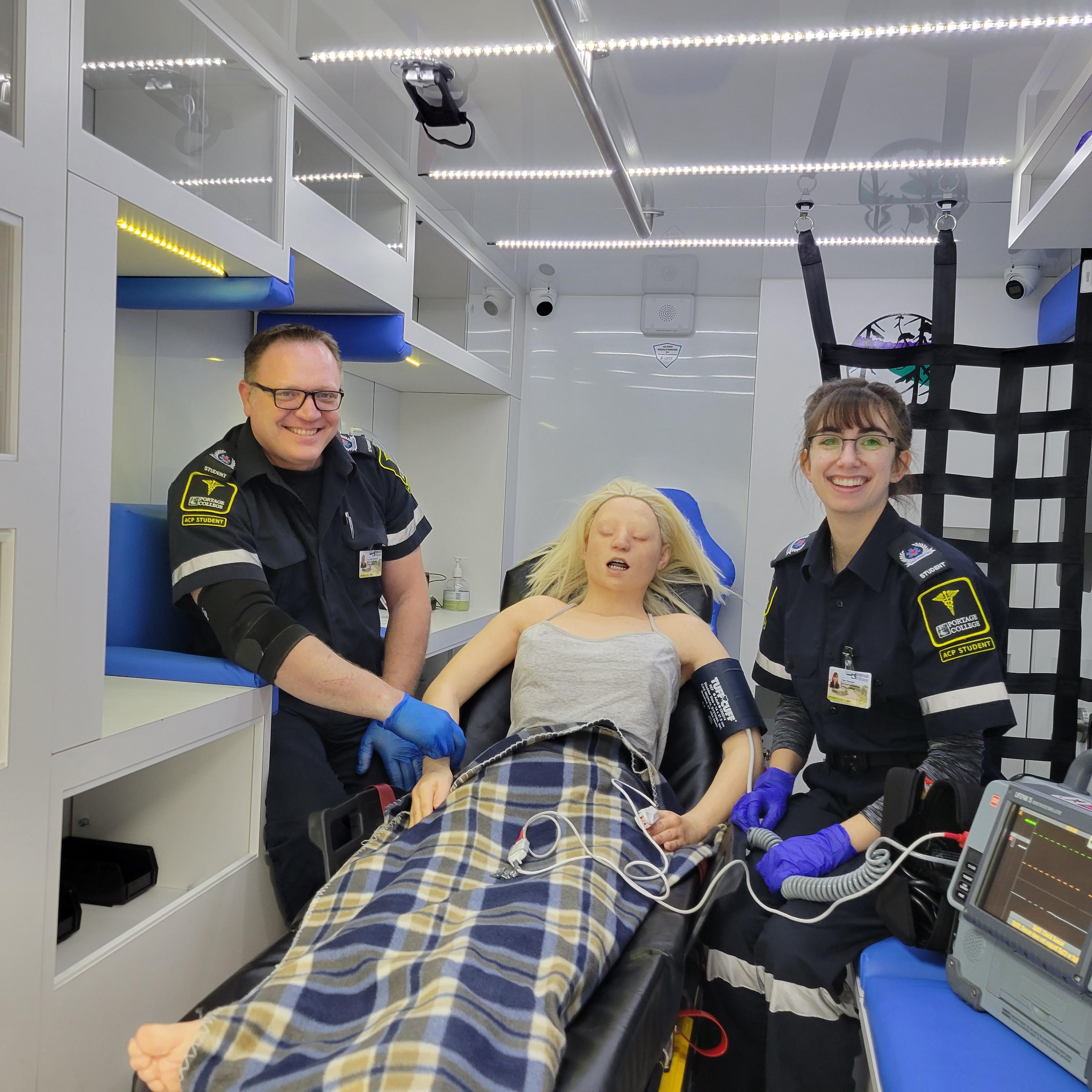 Cory Christopherson and his step-daughter Taylor Resendes in the ACP simulator at Portage College.