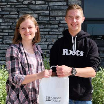 Jaime Davies of Portage College presenting Riley Woodruff with his free tuition prize